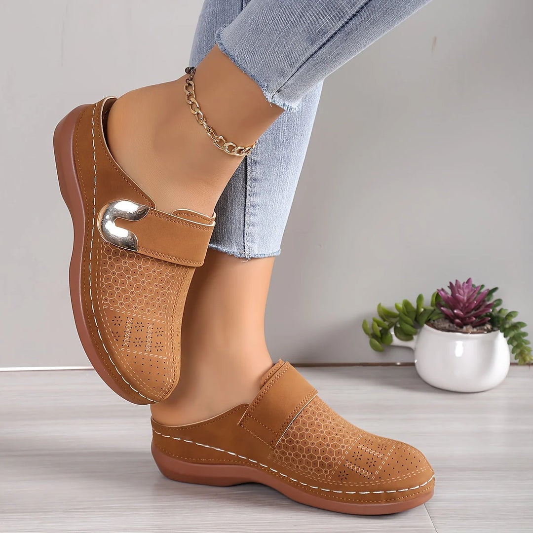 Close-up of women's slip-on mules showing cushioned footbed and non-slip sole construction