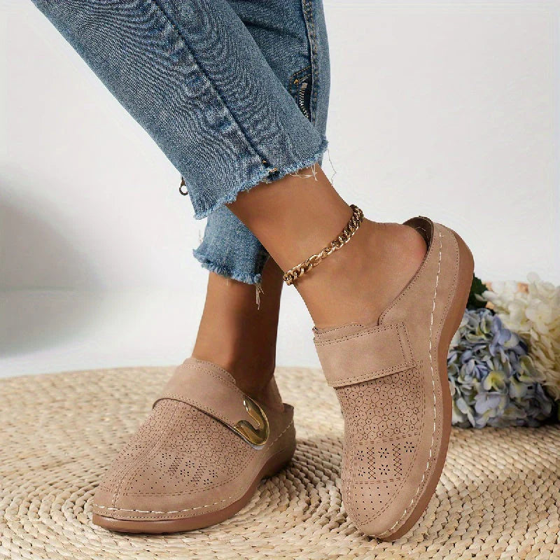 Side view of women's slip-on mules with contrast stitching and moulded footbed design