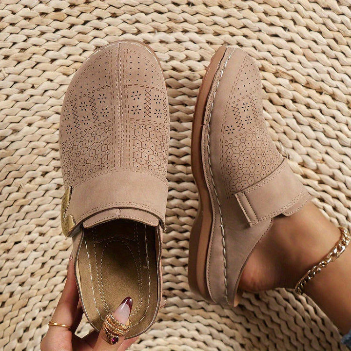 Women's slip-on mules worn with denim jeans and beaded ankle bracelet showing slip-on style