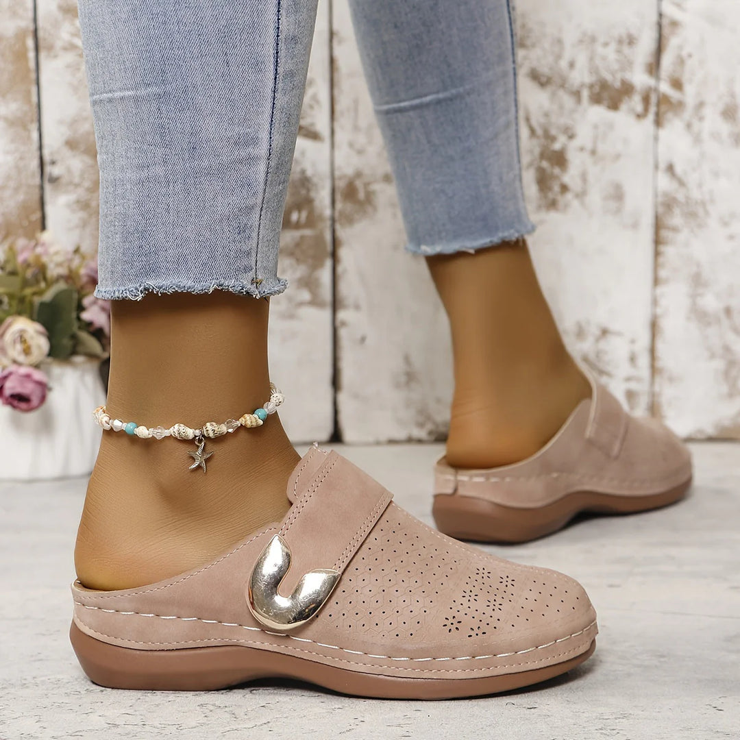 Women's slip-on mules on feet showing comfortable fit and casual styling with jeans