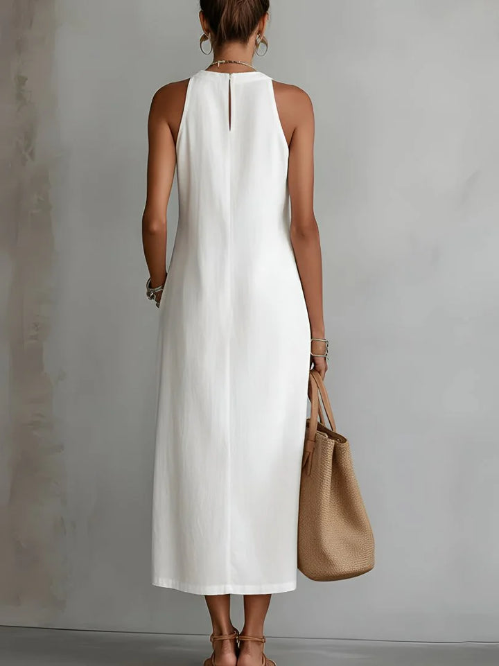 Side view showing relaxed silhouette and side slit of embroidered midi dress