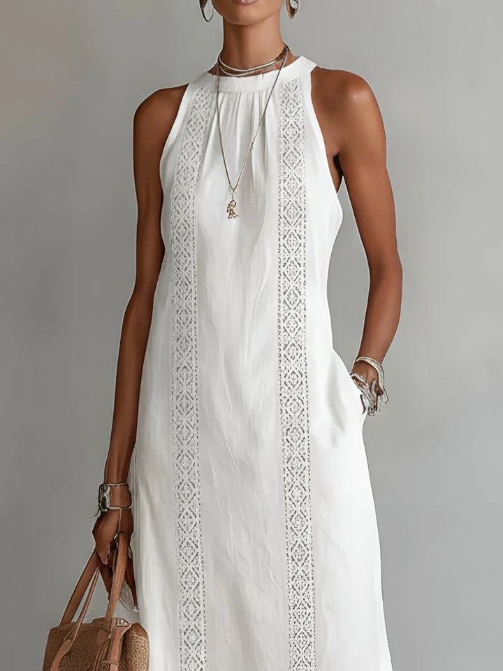 Woman styling embroidered sleeveless midi dress with sandals for casual summer look