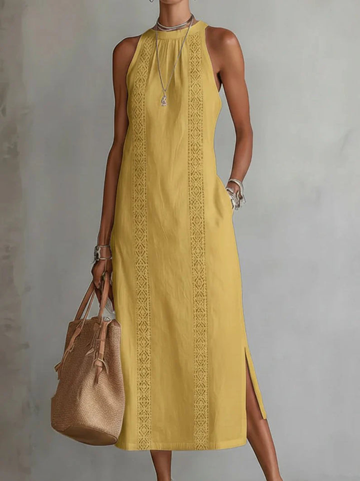Woman wearing embroidered midi dress styled with accessories for evening occasion