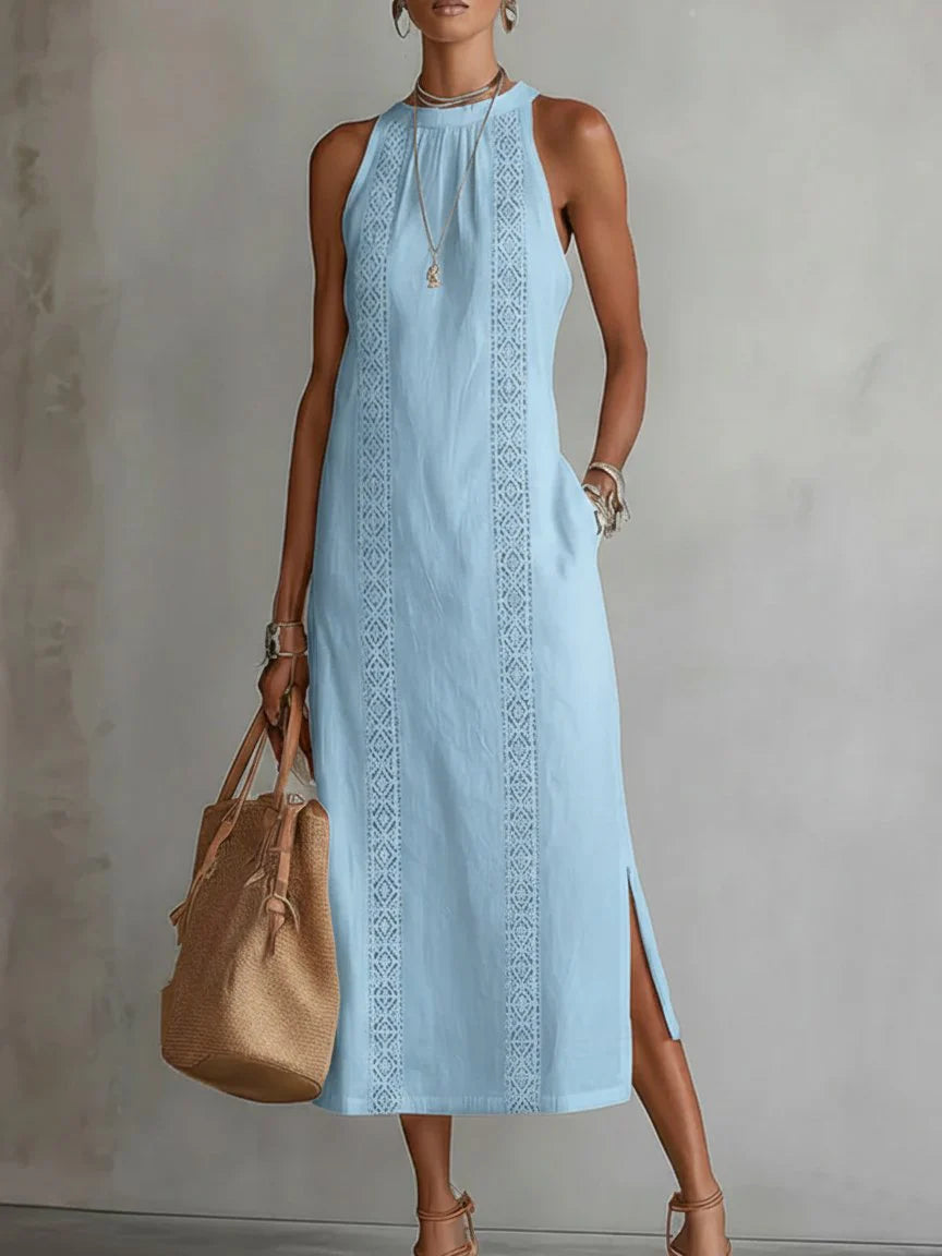 Embroidered midi dress paired with handbag for daytime summer styling