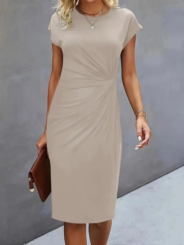 Below-the-knee hem length on fitted bodycon midi dress with ruched waist