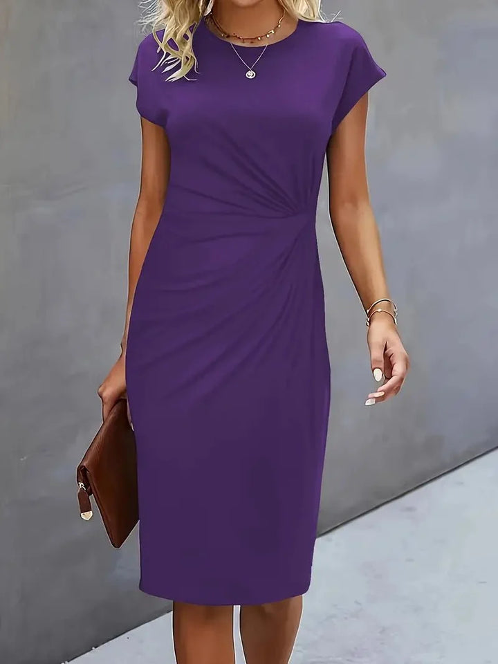 Bodycon midi dress styled with heeled court shoes for smart-casual occasion
