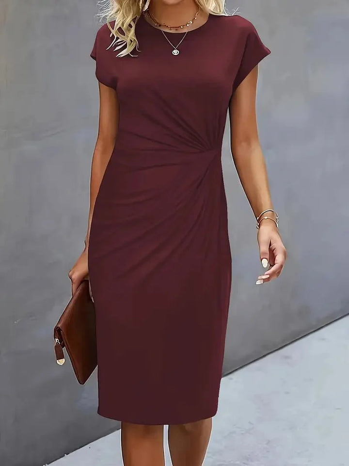 Twist-ruched waist detail creating waist-defining drape on fitted midi dress