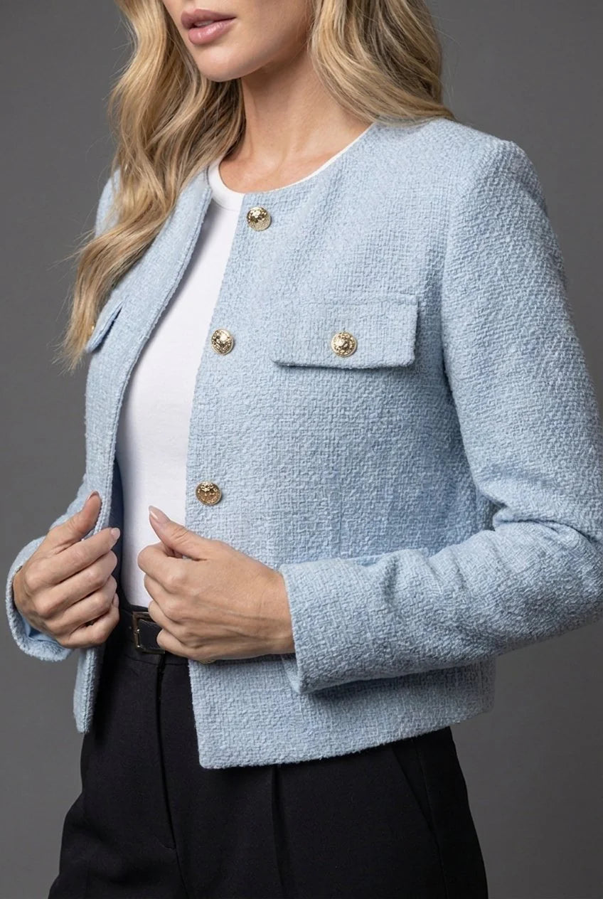 Side view of tailored cropped blazer showing structured silhouette and long sleeves