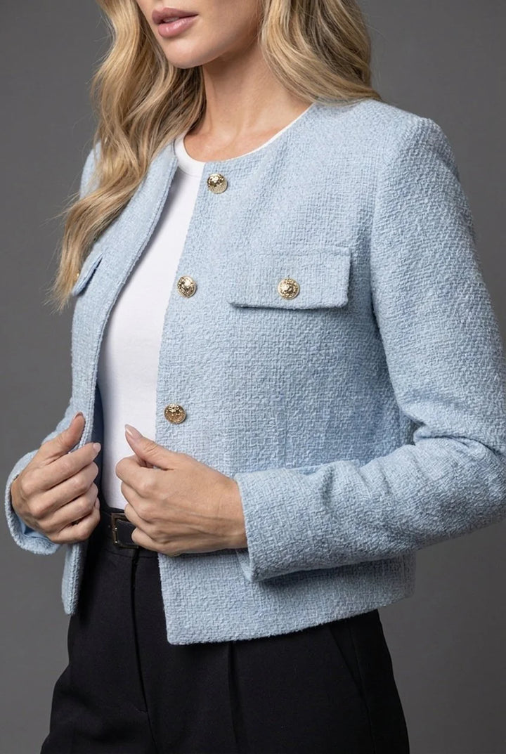 Side view of tailored cropped blazer showing structured silhouette and long sleeves