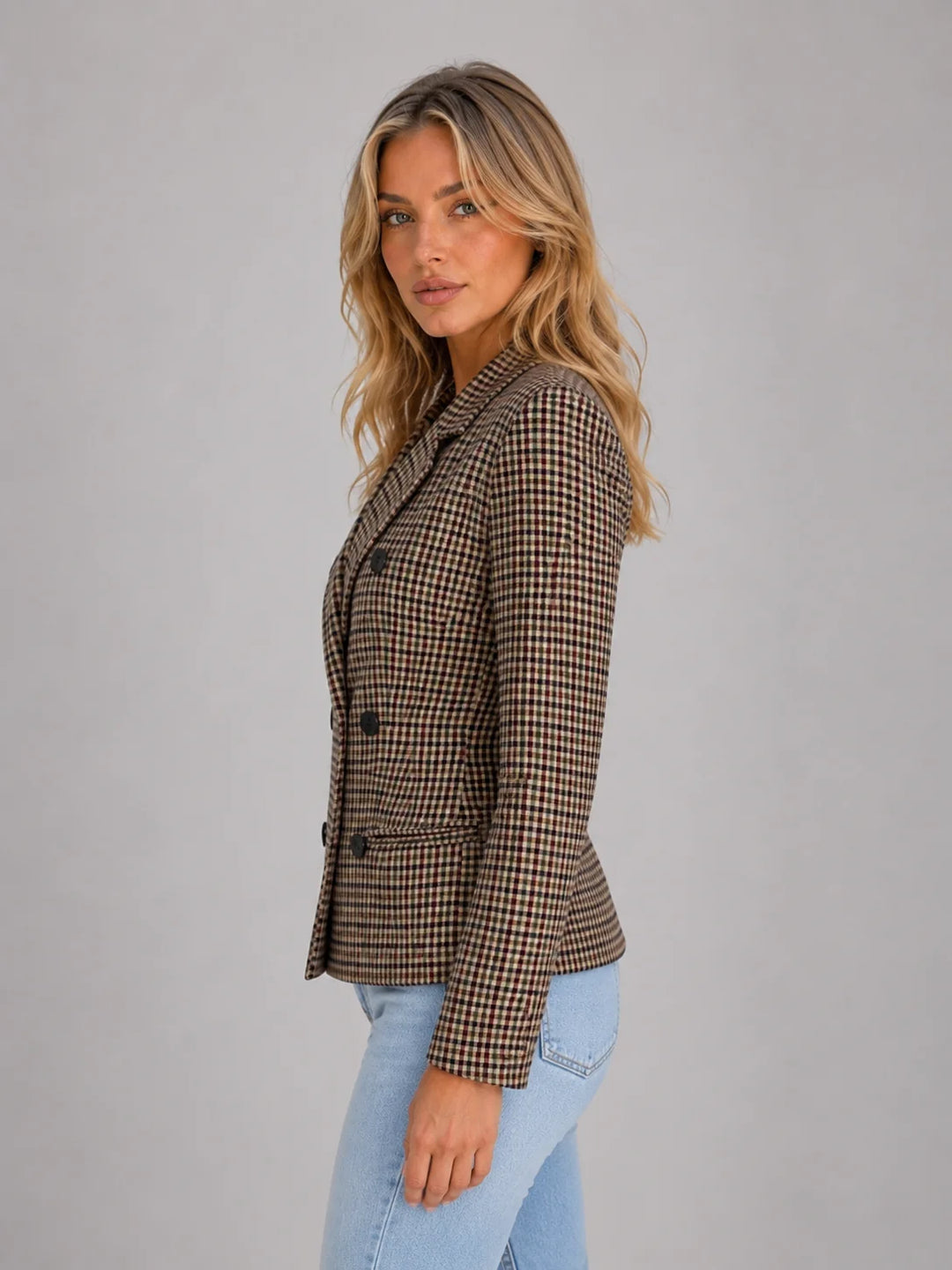 Close-up detail of women's checked blazer featuring flap pockets and decorative button detailing