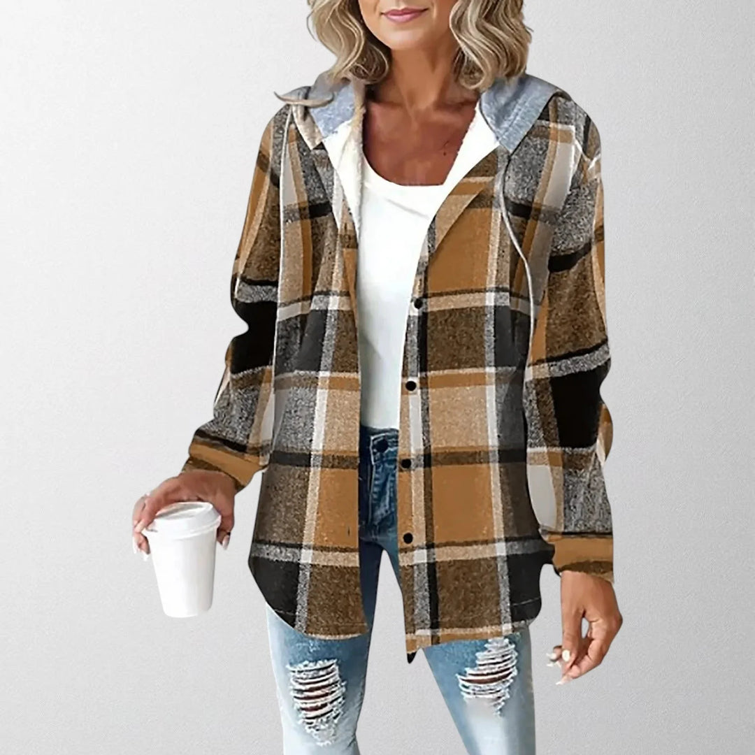 Woman styling casual warm jacket over white top with distressed denim for everyday layering look