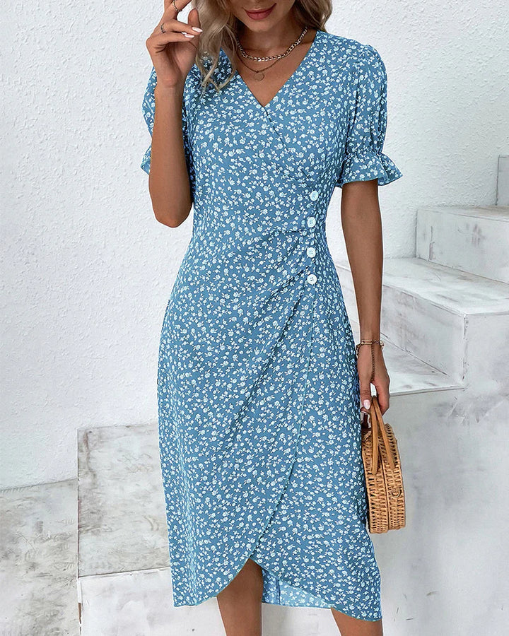 Detail of V neckline and wrap front closure on floral midi dress with tie waist feature