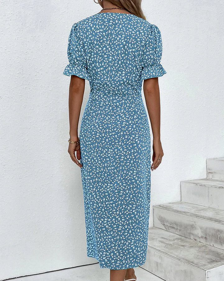 Detail shot of floral print pattern on green wrap dress with white ditsy floral motif