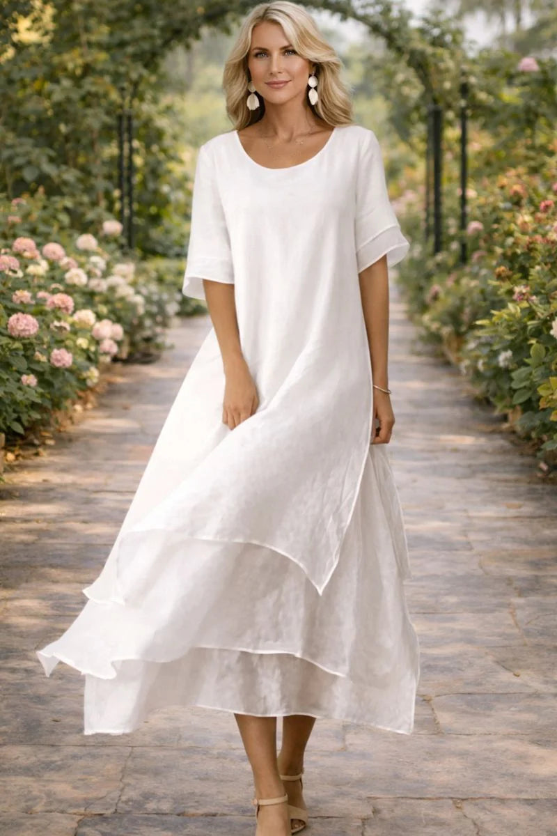 Close-up view of layered midi dress showing mesh sleeve detail and flowing tiered skirt construction