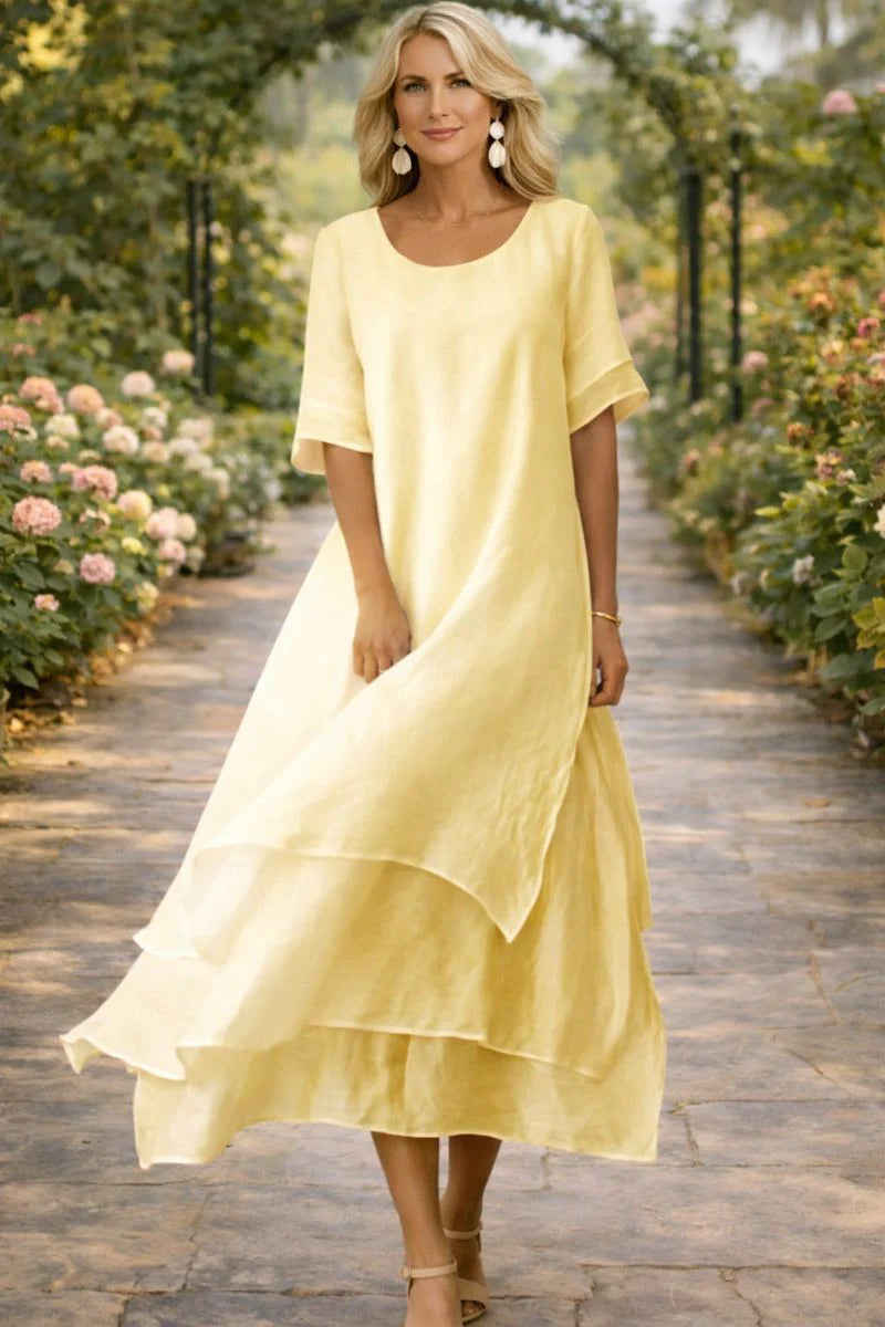 Side angle of layered midi dress displaying relaxed fit and mid-calf length with graceful drape