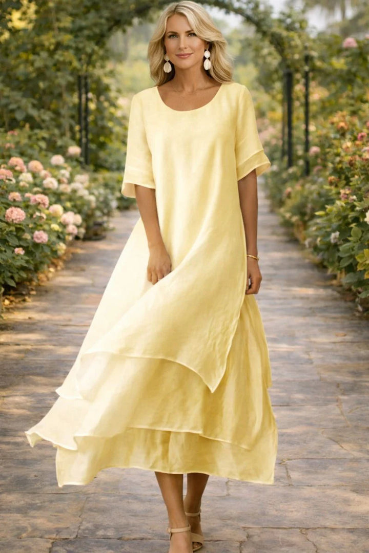 Side angle of layered midi dress displaying relaxed fit and mid-calf length with graceful drape