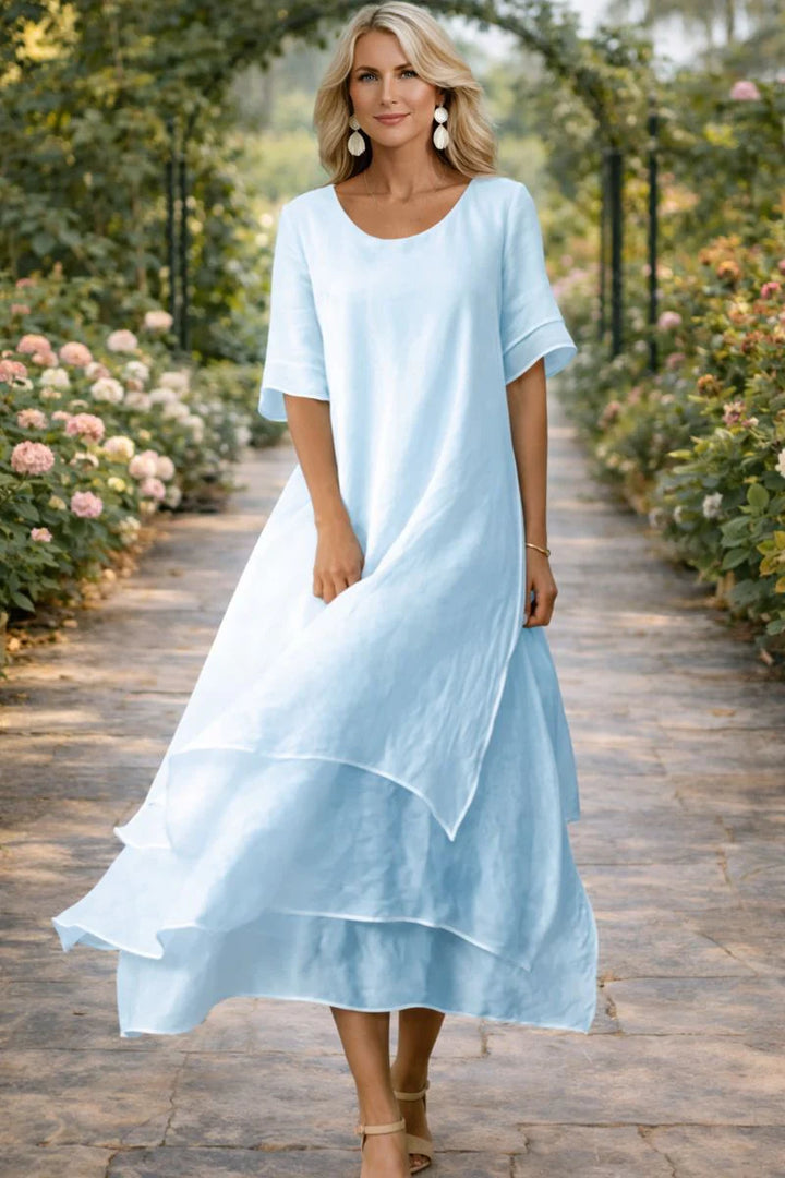 Full-length view of layered midi dress showing scoop neckline and multi-tiered hem design