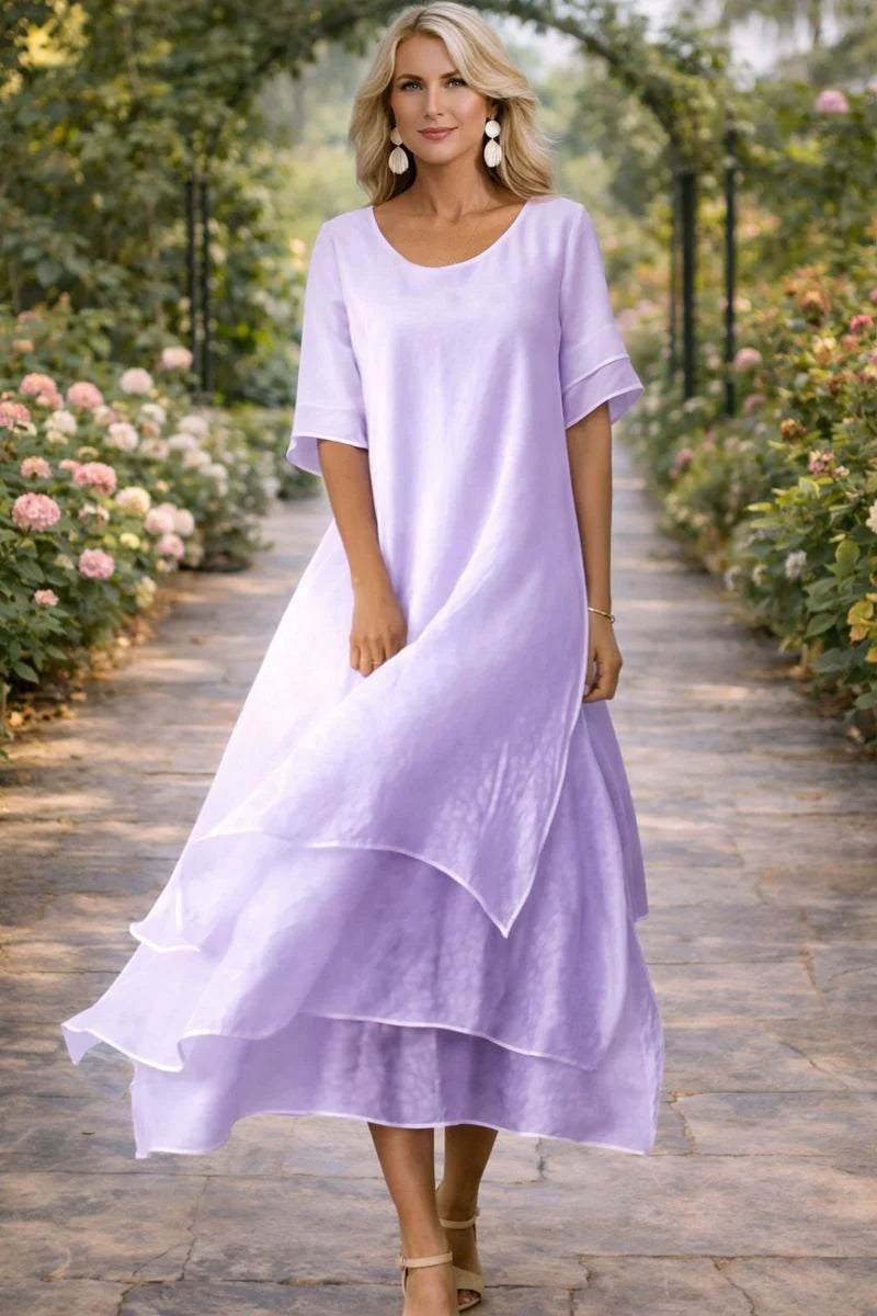 Detail shot of layered midi dress highlighting soft fabric texture and flowing silhouette