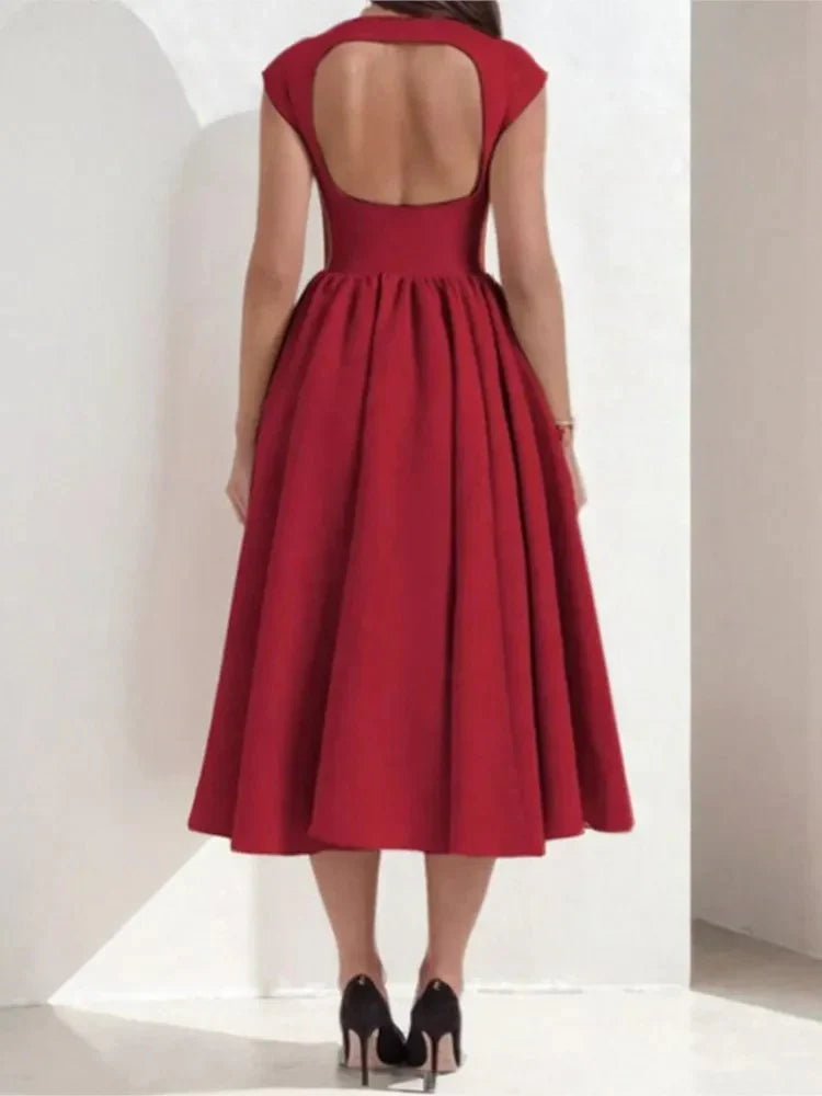 Tea length dress with dramatic full skirt and structured fabric creating volume and movement