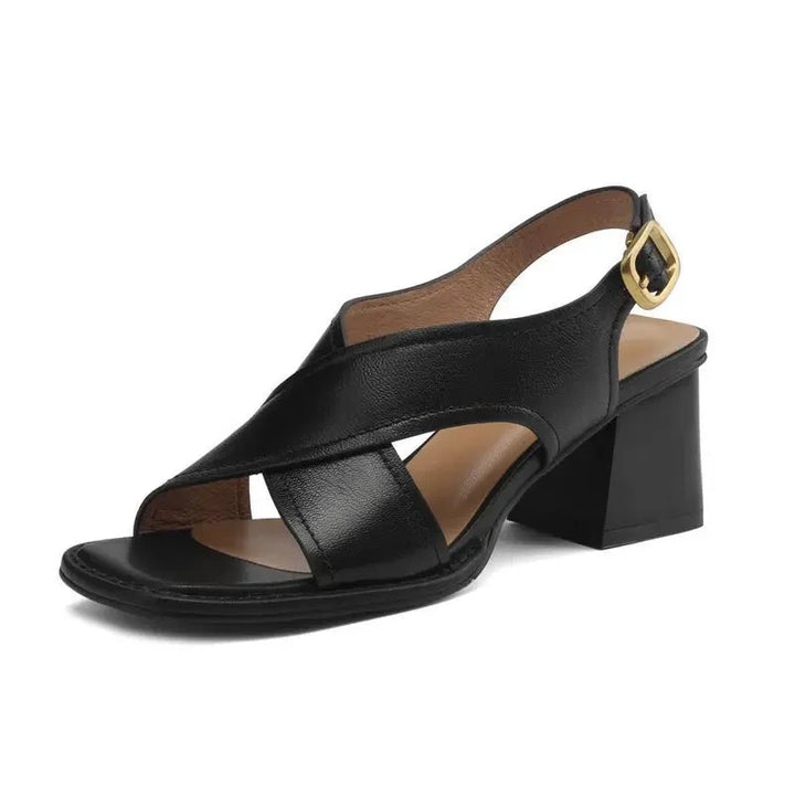 Women's block heel sandals in black leather displaying comfortable fit and walkable heel height