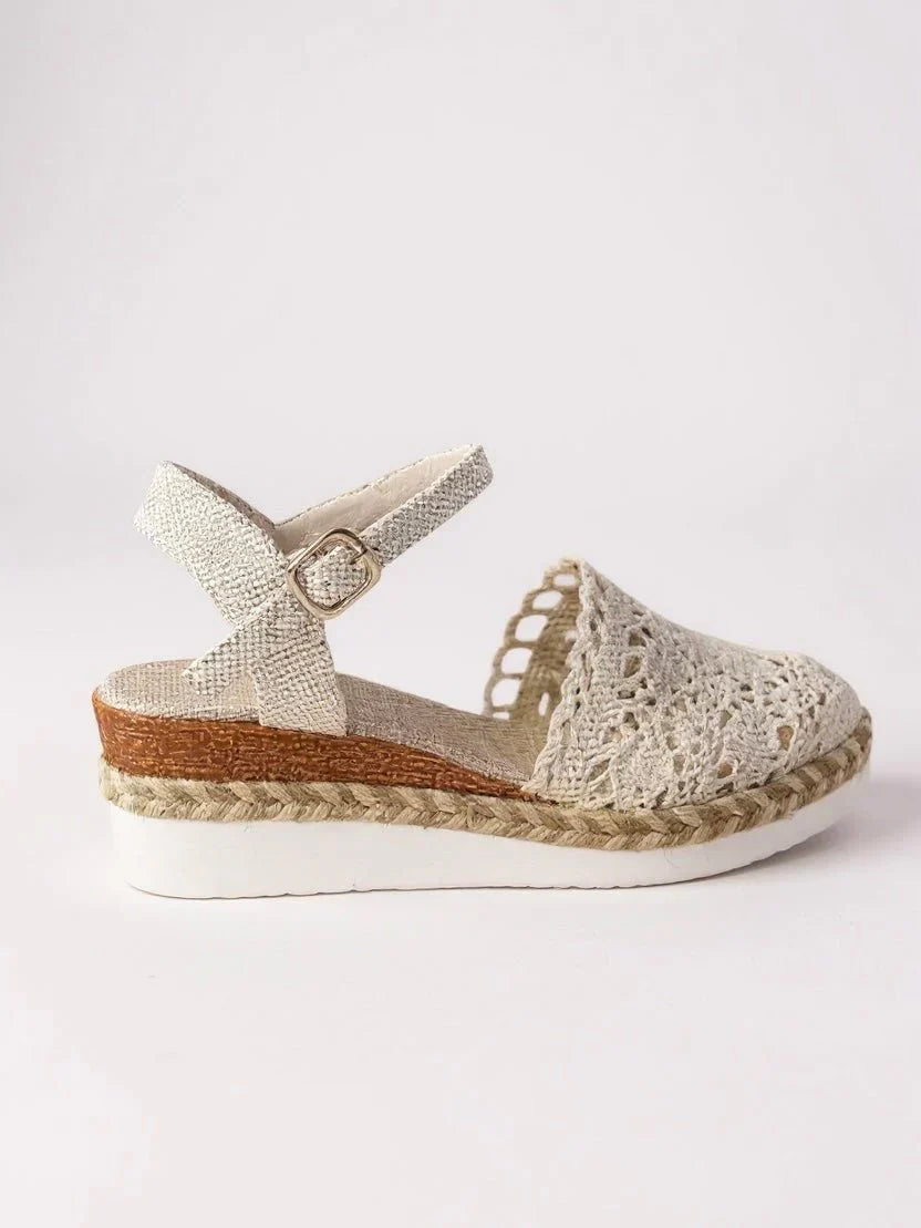 Detail shot of boho platform sandals showing crochet pattern and adjustable ankle strap buckle