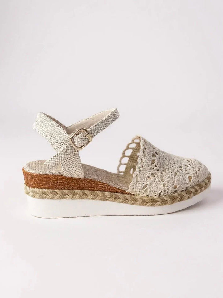Detail shot of boho platform sandals showing crochet pattern and adjustable ankle strap buckle