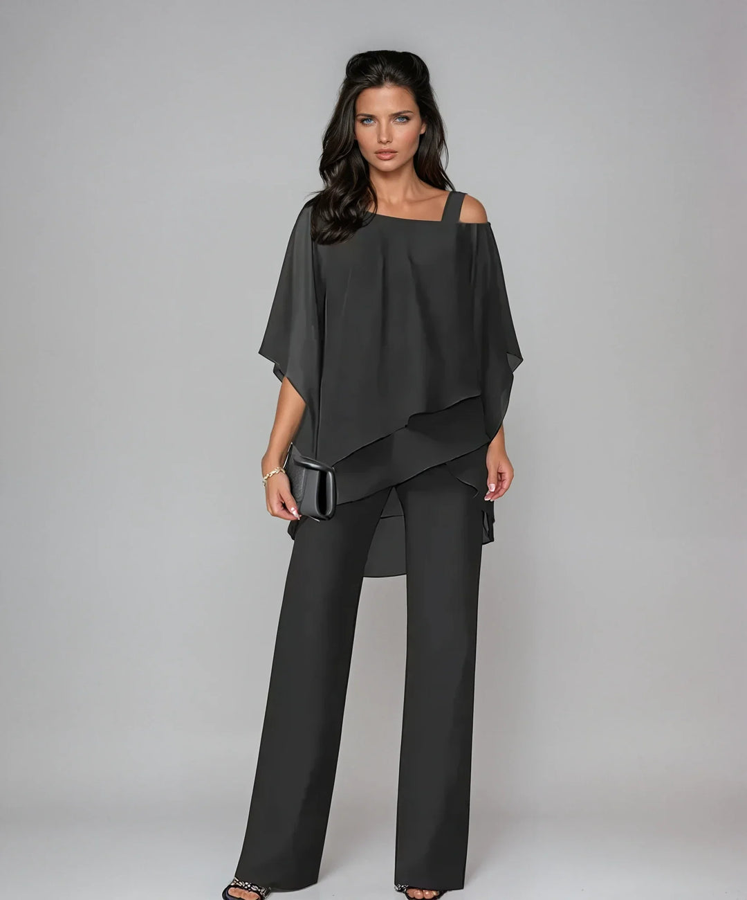 Close-up of cold shoulder detail and asymmetric layered overlay on women's two-piece set
