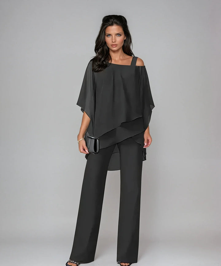 Close-up of cold shoulder detail and asymmetric layered overlay on women's two-piece set