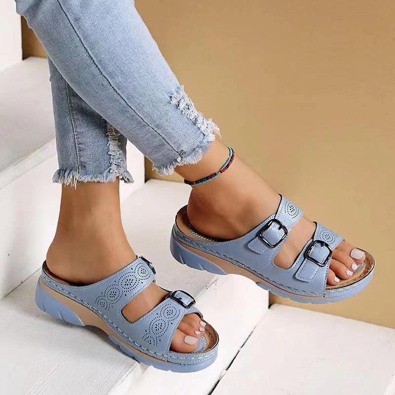 Women's casual slide sandals with adjustable buckles and cushioned footbed worn for relaxed summer styling