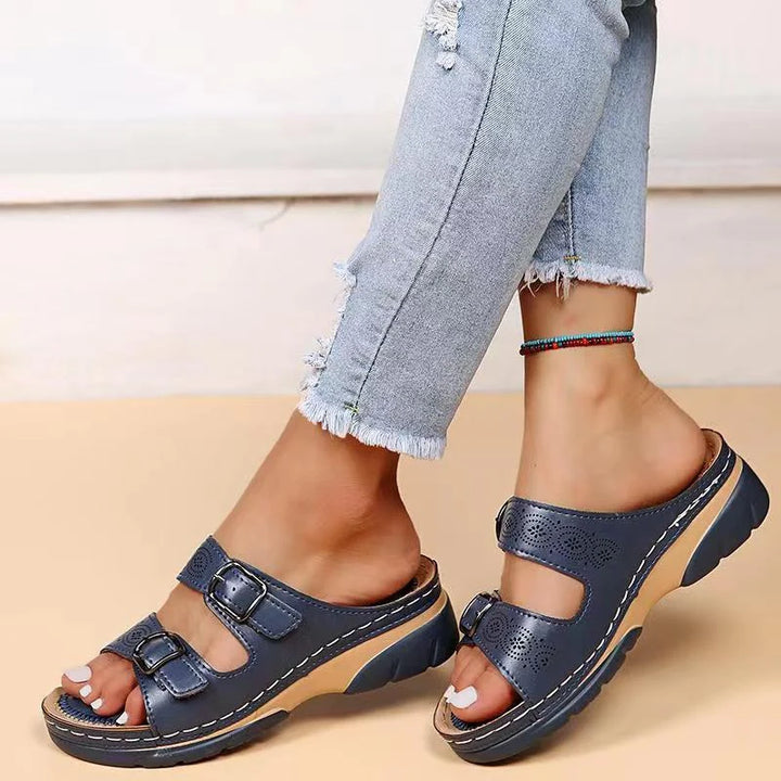 Side angle of women's buckle sandals showing contoured footbed and textured sole with adjustable buckle fastenings