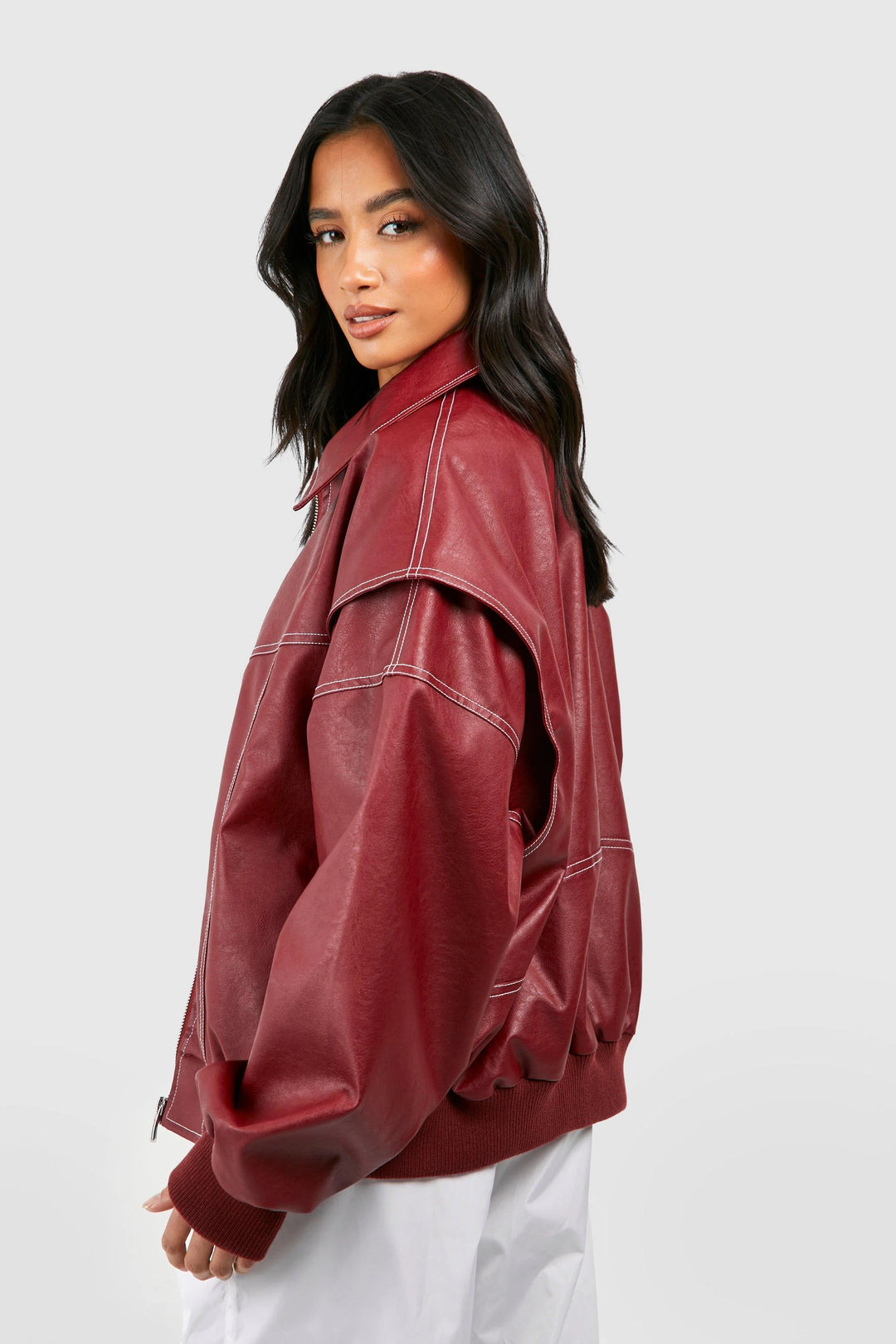 Woman styling black classic bomber jacket with white tee and dark jeans for casual layering
