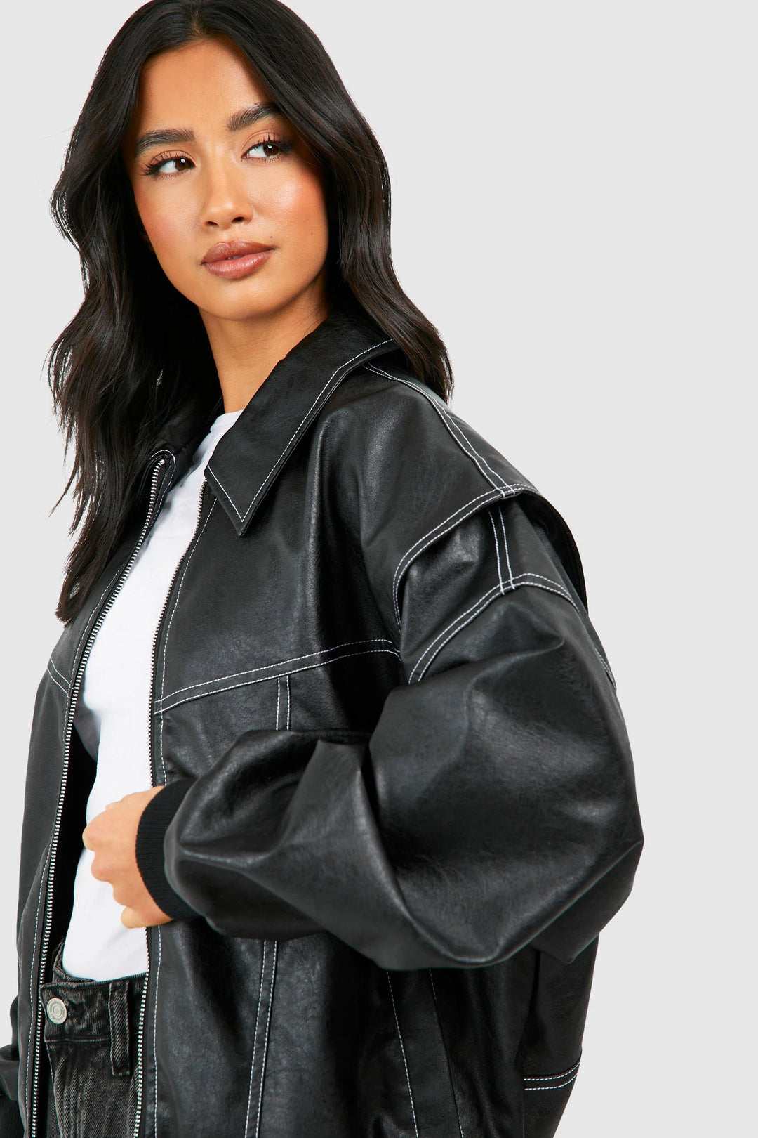 Classic bomber jacket styled over casual outfit highlighting versatile layering design