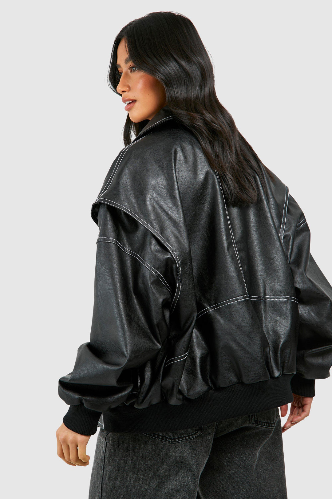 Close-up of side pockets and zip closure on black classic bomber jacket