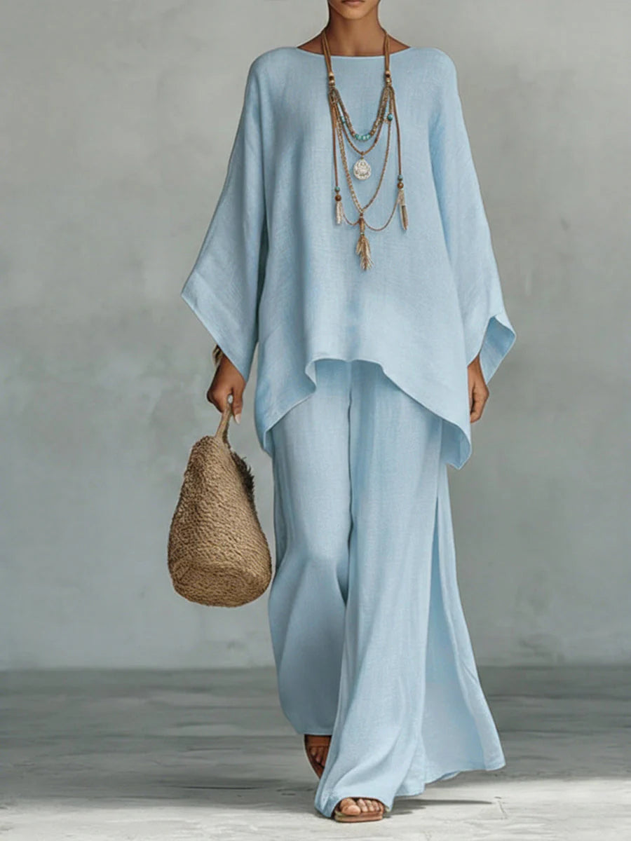 Relaxed fit linen co-ord showing flowing wide-leg trousers and asymmetric hem top detail