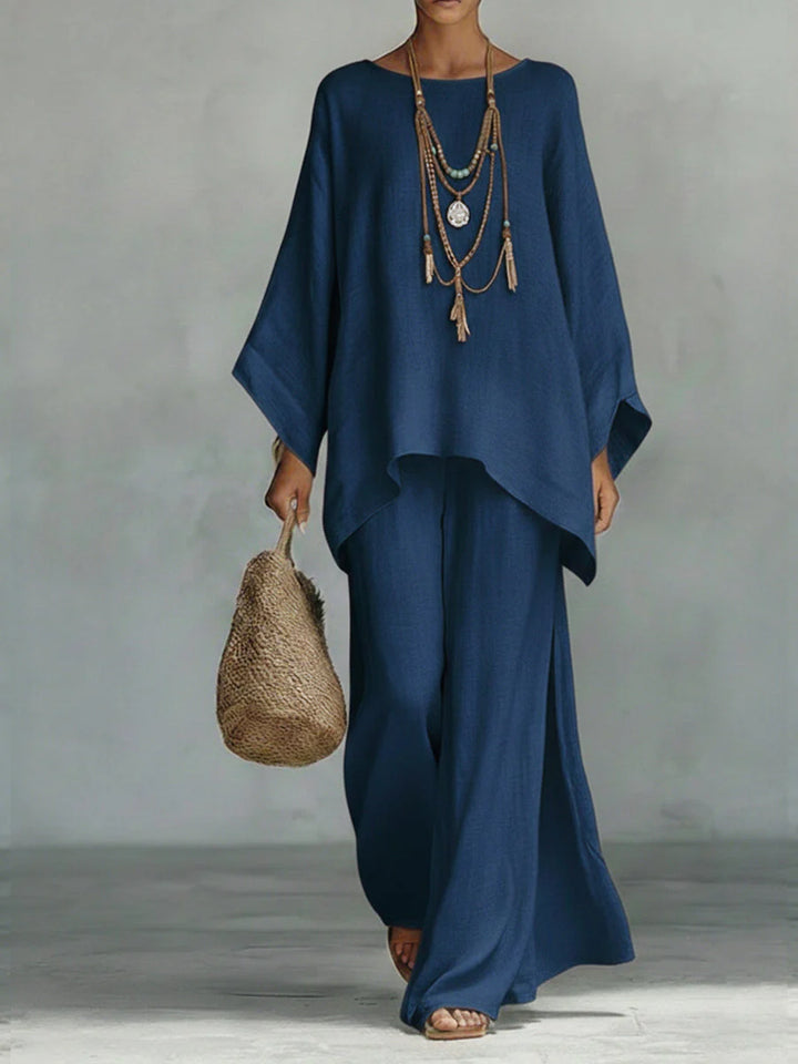 Linen two-piece set styled with woven bag and layered necklaces for casual elegance