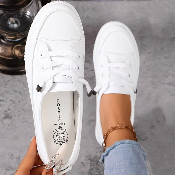 Women's white lace-up trainers with platform sole and cushioned insole, styled with denim