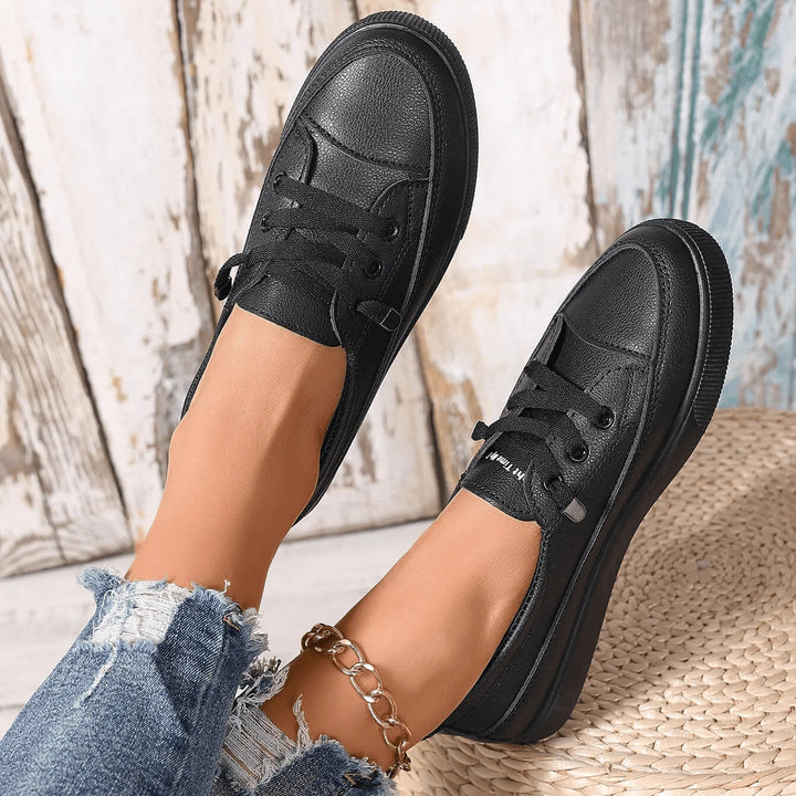 Overhead view of women's white lace-up trainers showing rounded toe and platform sole