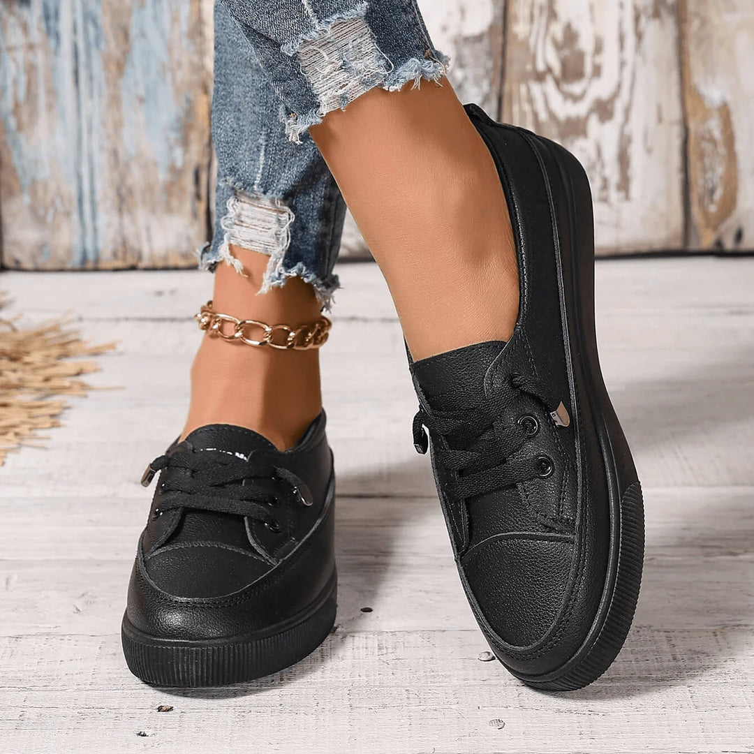 Women's white trainers styled with jeans, showcasing versatile everyday design