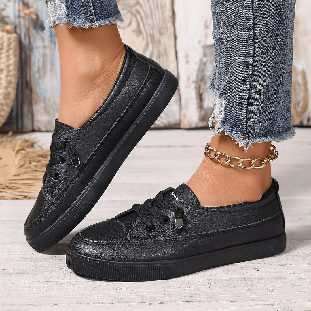 Close-up of women's white trainers highlighting structured upper and comfortable collar