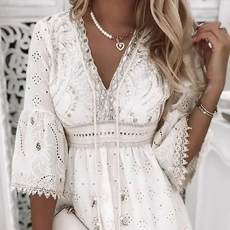 Back view of boho mini dress showing A-line silhouette and eyelet lace construction throughout