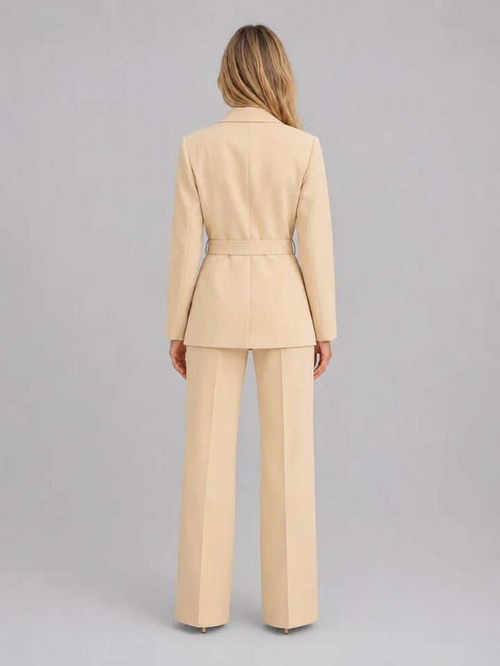 Front view of tailored two-piece suit featuring belted blazer and high-waisted wide leg trousers