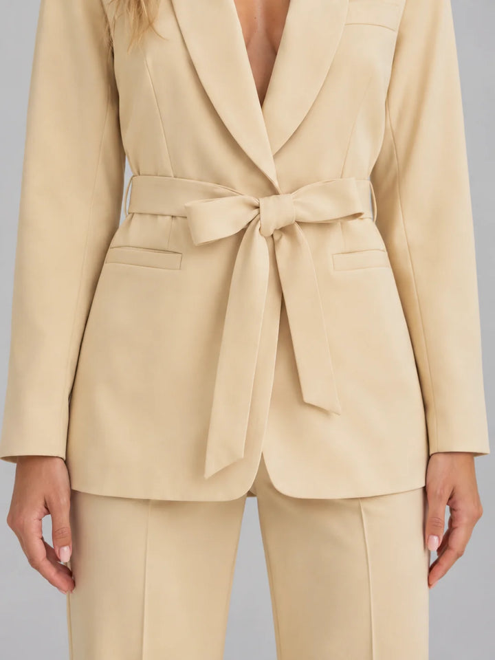 Close-up of shawl collar blazer with adjustable self-tie waist belt and structured fabric