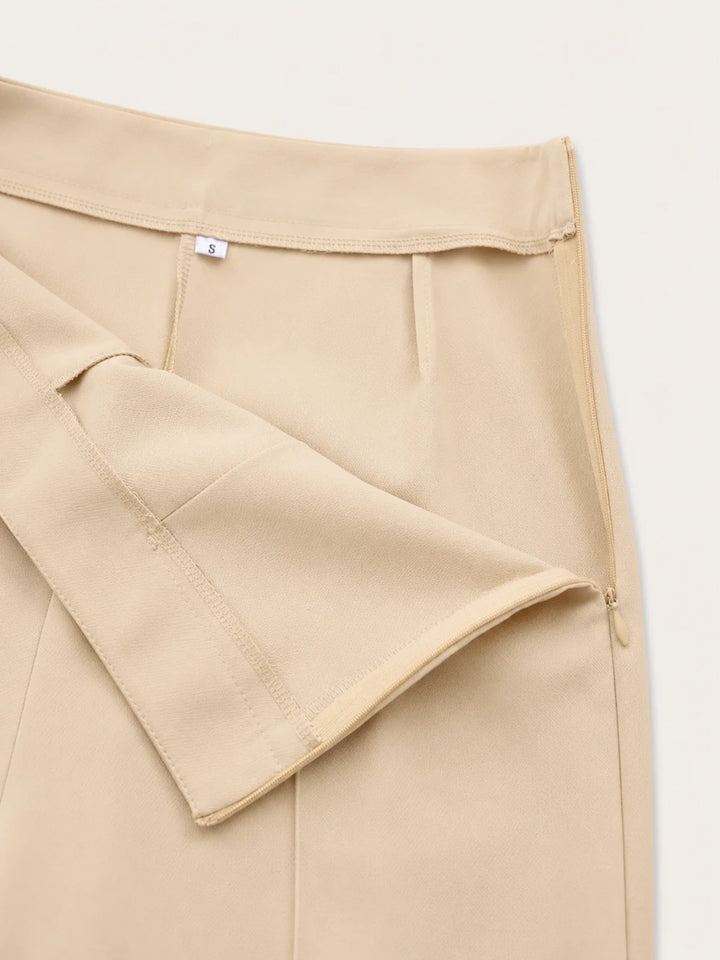 Detail of high-waisted wide leg trousers with clean lines and elongated fit
