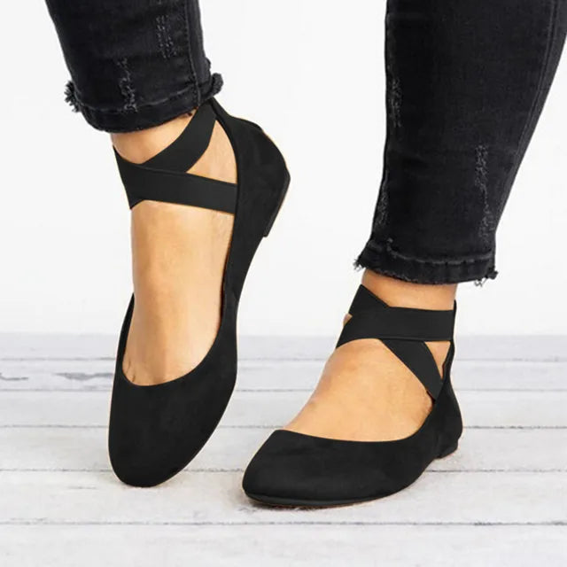 Side view of women's ballet flats showing cross-strap ankle design and flat sole