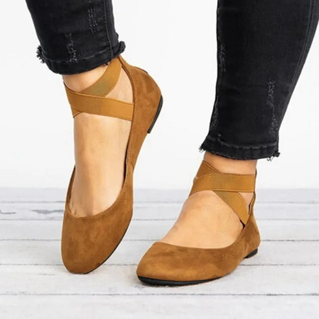 Close-up of cross-strap detail on women's ballet flats with smooth upper finish
