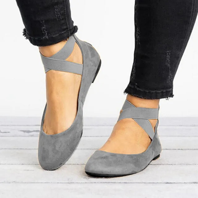 Women's ballet flats paired with black distressed jeans for casual spring styling