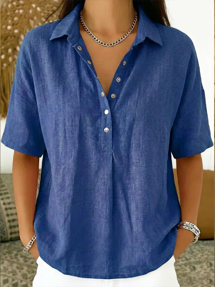 Side view of relaxed fit linen shirt with short sleeves and curved hem
