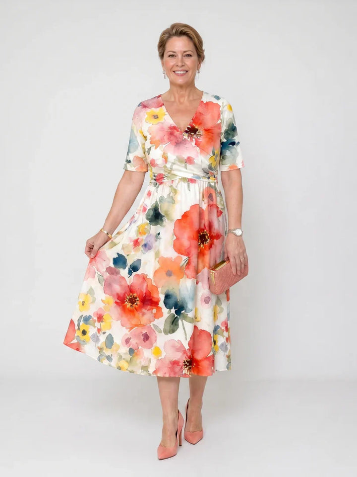 Floral midi dress with V-neckline, short sleeves, and vibrant watercolour print on flowing fabric