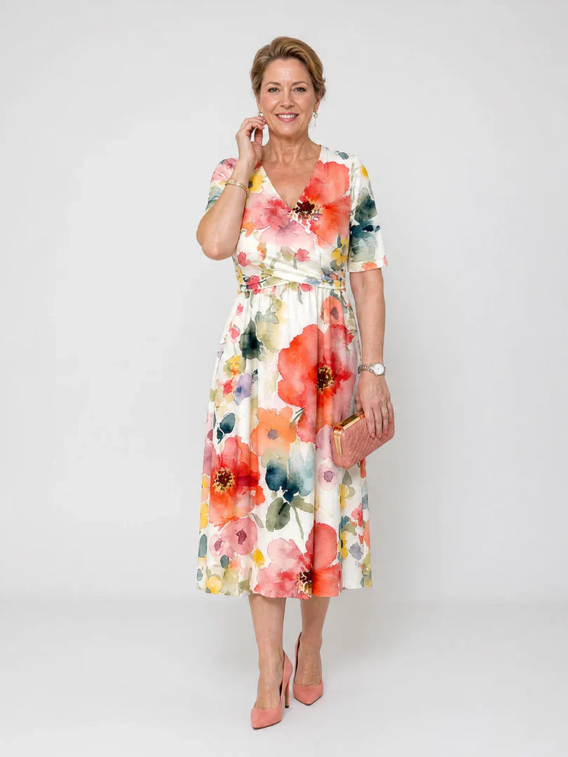 Close-up view of floral midi dress showing wrap-style bodice and gathered waist detail