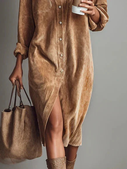 Midi length corduroy dress styled with ankle boots for casual autumn wear